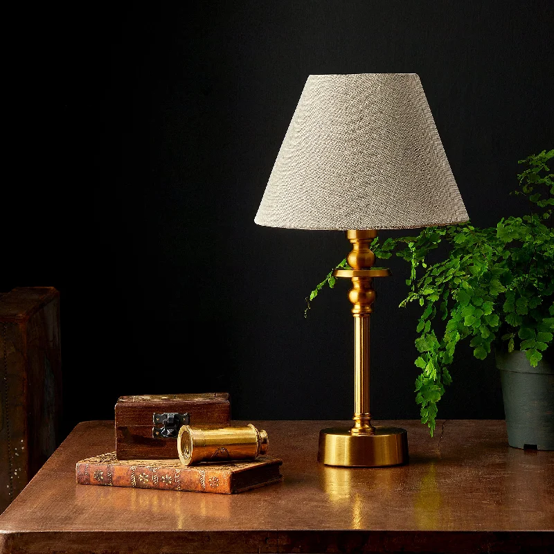 wooden table lamps with natural grain for a warm and organic feelPhileas rechargeable table lamp finished in antique brass